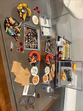 Miniature Food Display with Red Sausages and Yellow Corn